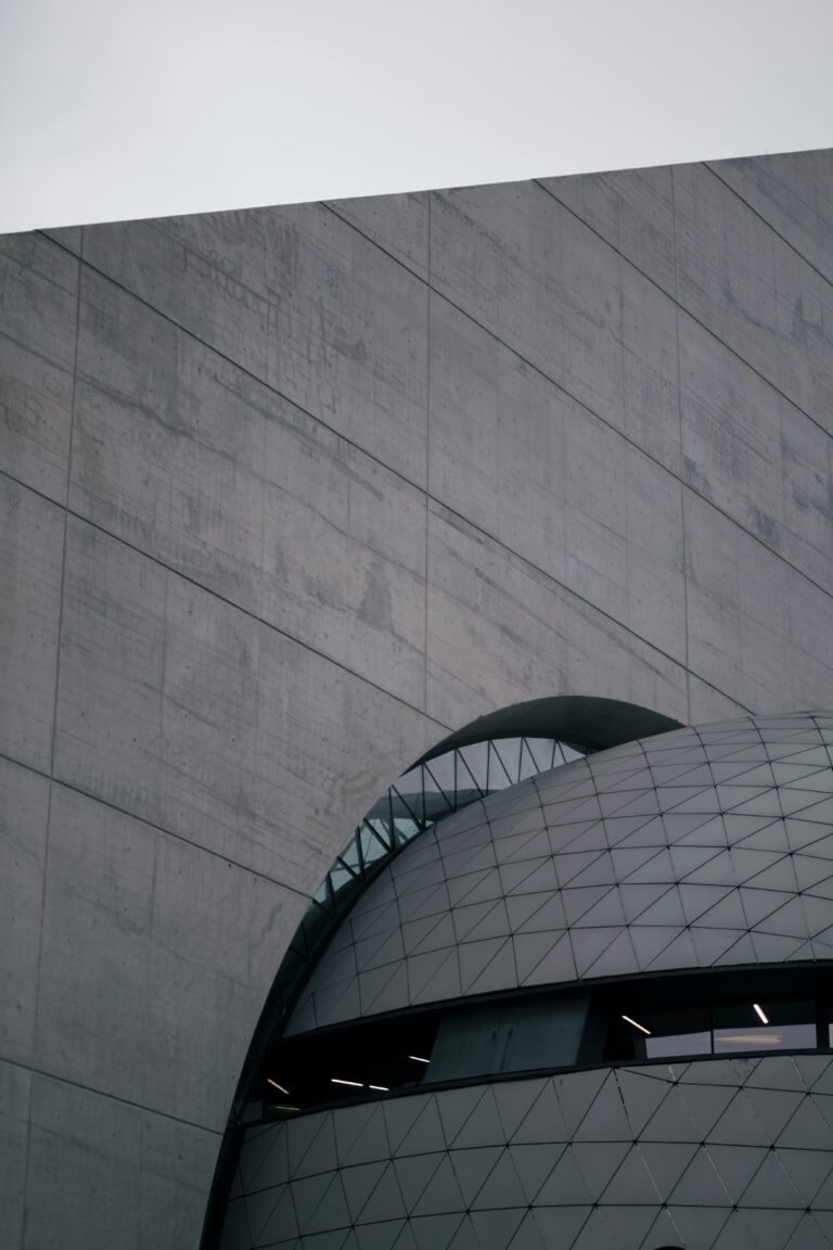 Close-up of a gray geometric building facade showcasing modern architectural design.